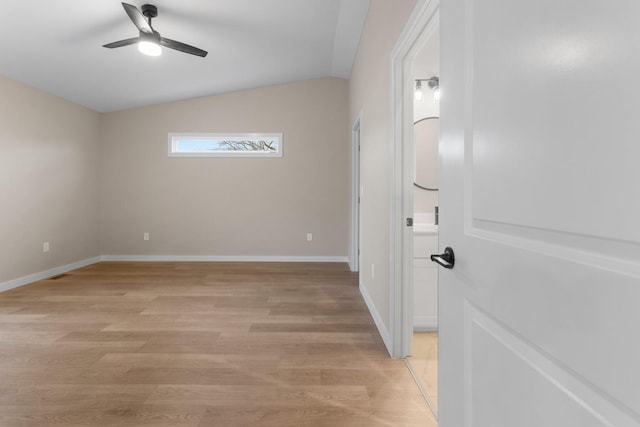 empty room with ceiling fan, light hardwood / wood-style flooring, and lofted ceiling