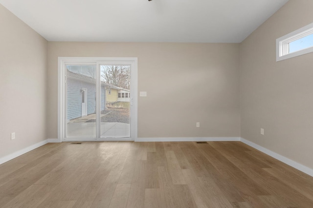 spare room featuring light hardwood / wood-style floors