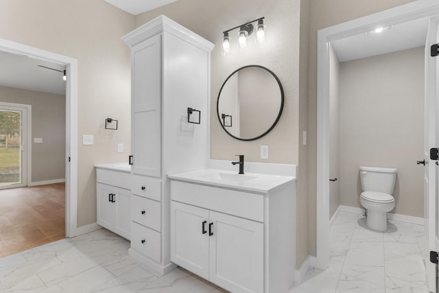 bathroom featuring vanity and toilet