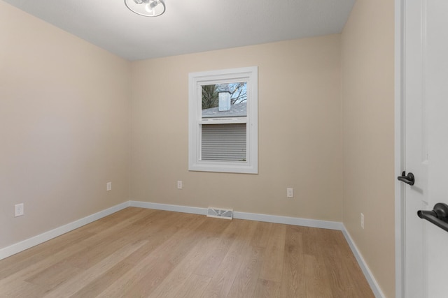 spare room featuring light hardwood / wood-style flooring