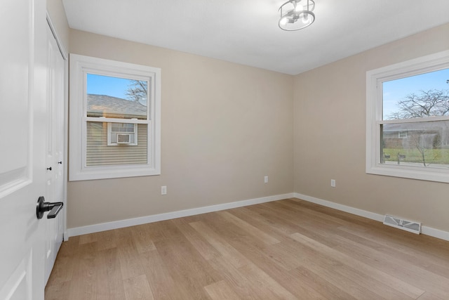 empty room with light hardwood / wood-style flooring