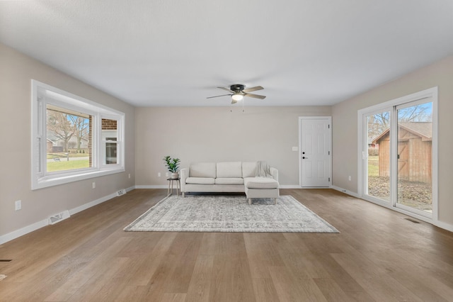 unfurnished living room with light hardwood / wood-style flooring and ceiling fan