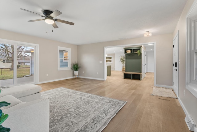 living room featuring ceiling fan and light hardwood / wood-style flooring