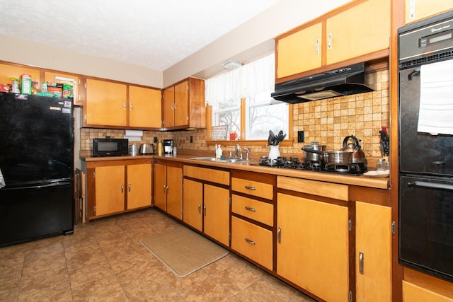 kitchen featuring decorative backsplash, sink, and black appliances