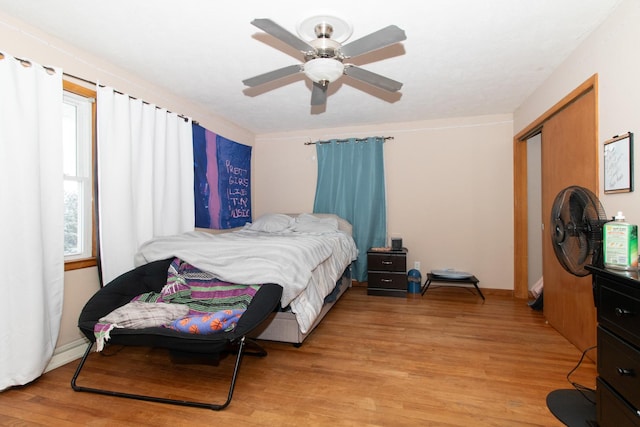 bedroom featuring a closet, ceiling fan, and light hardwood / wood-style flooring