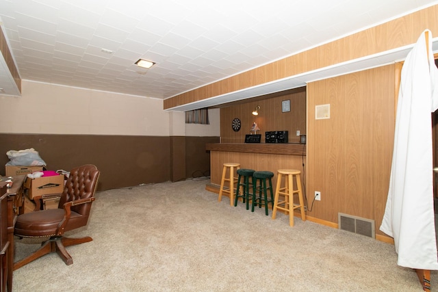 bar featuring wood walls and carpet floors