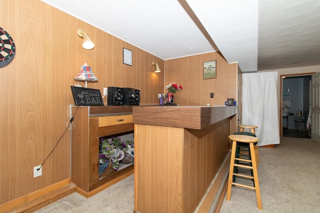 bar featuring wood walls and light carpet