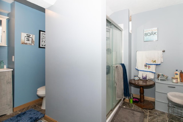 bathroom featuring toilet and a shower with door