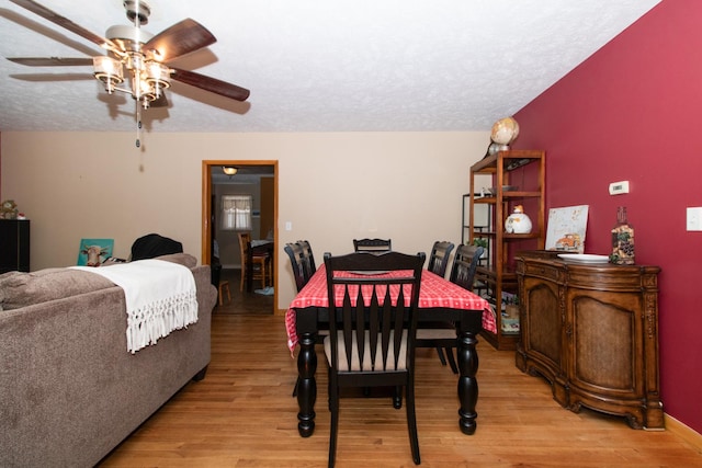 dining room with ceiling fan, light hardwood / wood-style floors, and a textured ceiling