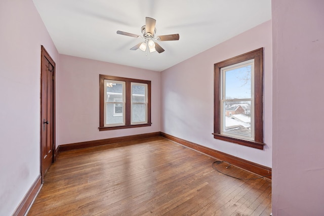 spare room featuring ceiling fan and hardwood / wood-style flooring