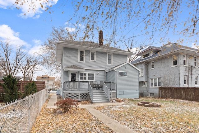 view of front of house featuring a wooden deck and a fire pit