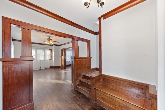 interior space with dark hardwood / wood-style flooring, ornate columns, and ornamental molding