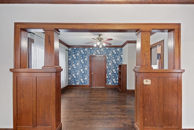 interior space featuring crown molding, dark wood-type flooring, and ornate columns