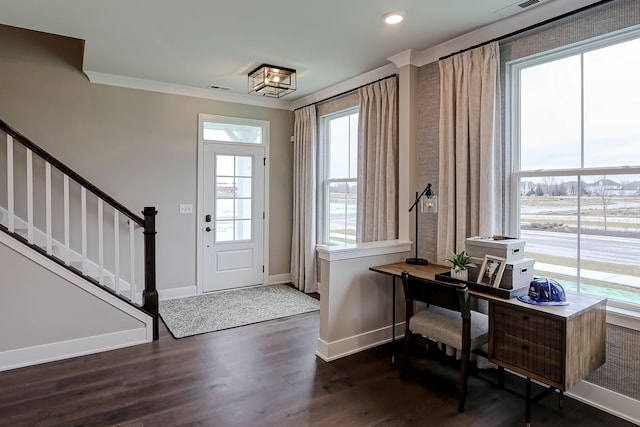 foyer entrance with dark hardwood / wood-style floors and ornamental molding