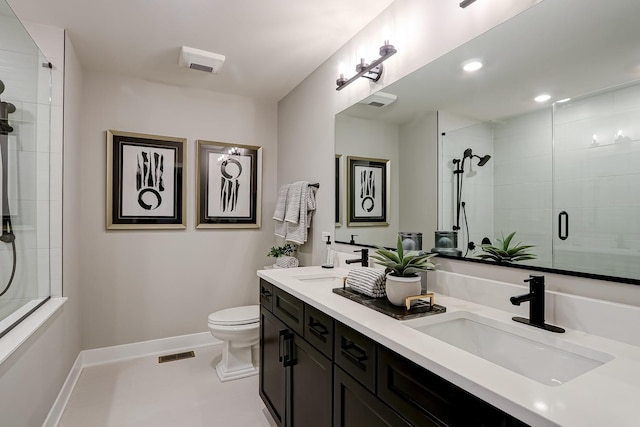 bathroom with vanity, an enclosed shower, and toilet