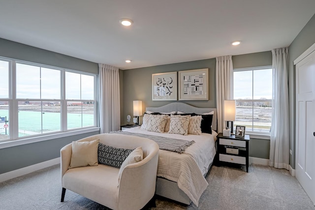 bedroom featuring a water view and carpet floors