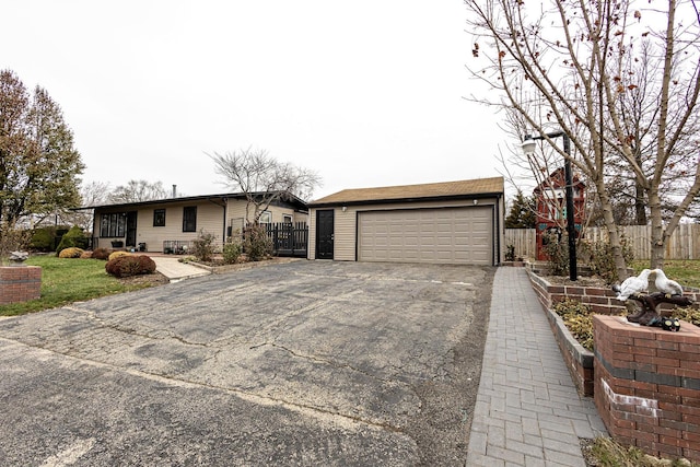 ranch-style home with an outdoor structure and a garage