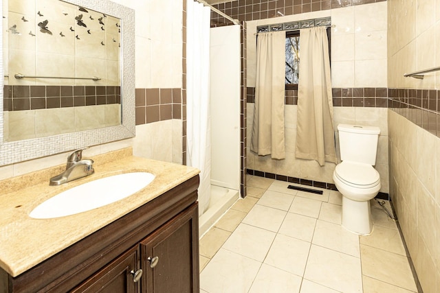 bathroom with a shower with curtain, tile patterned flooring, vanity, and tile walls