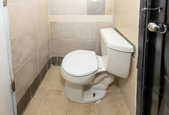 bathroom featuring tile patterned floors, vanity, tile walls, and walk in shower