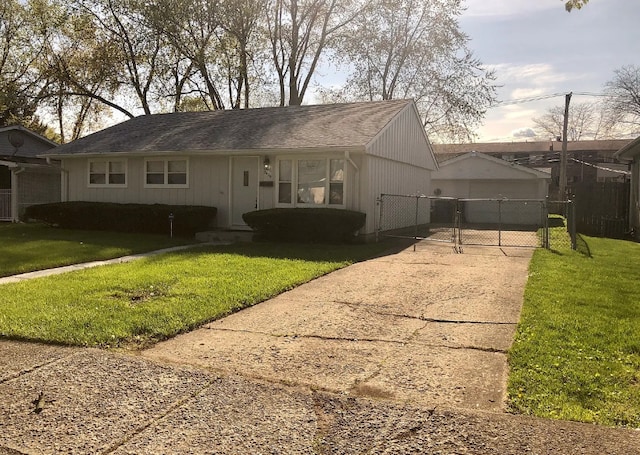 view of front of home with a front yard, concrete driveway, fence, and a gate