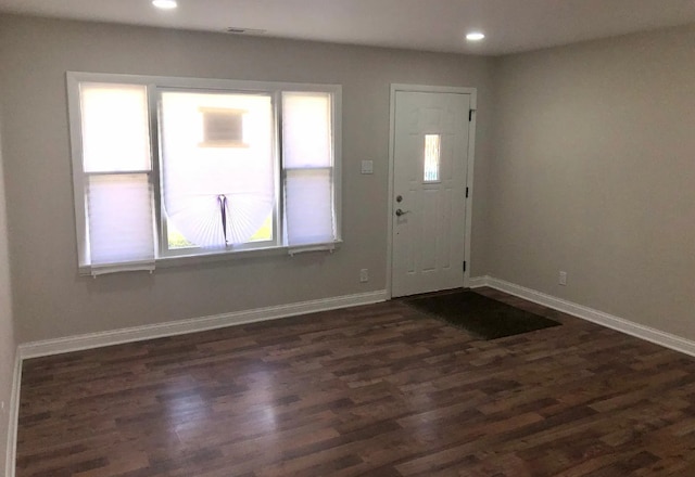 foyer with recessed lighting, dark wood finished floors, and baseboards