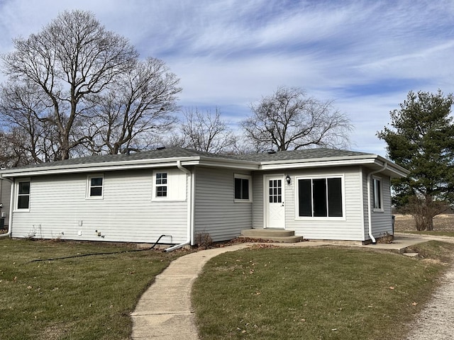 rear view of house with a yard