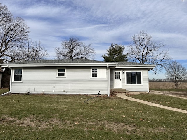 back of property featuring a lawn