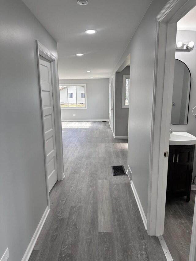 corridor with sink and dark hardwood / wood-style floors