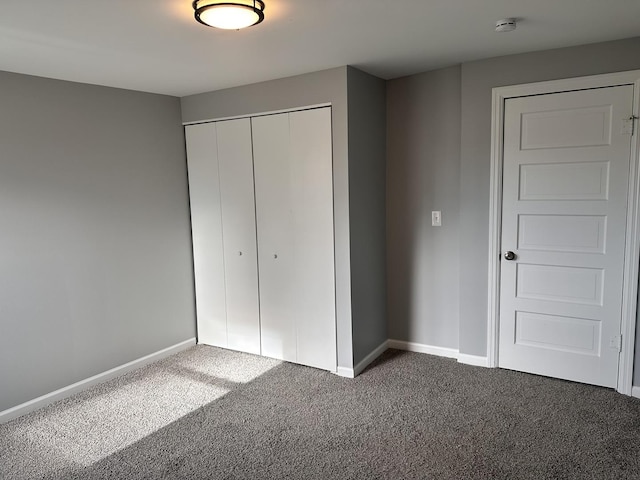 unfurnished bedroom with a closet and carpet floors