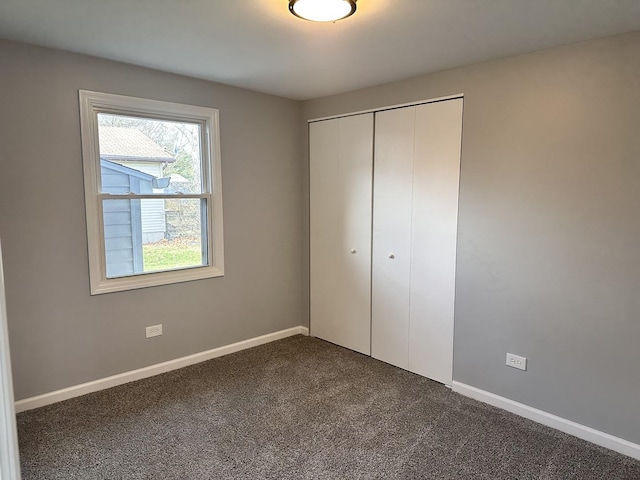 unfurnished bedroom featuring carpet flooring and a closet