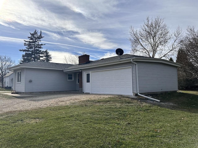 exterior space featuring a lawn and a garage