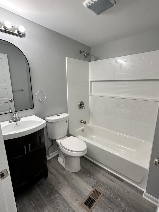 full bathroom featuring vanity, toilet, wood-type flooring, and tub / shower combination