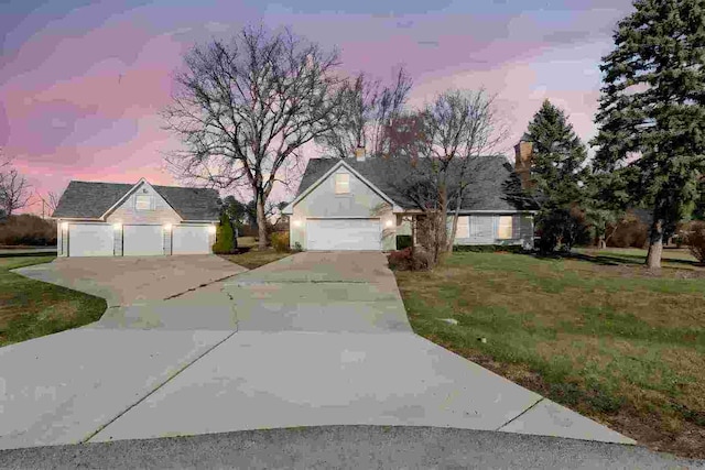 view of front of home with a lawn and a garage