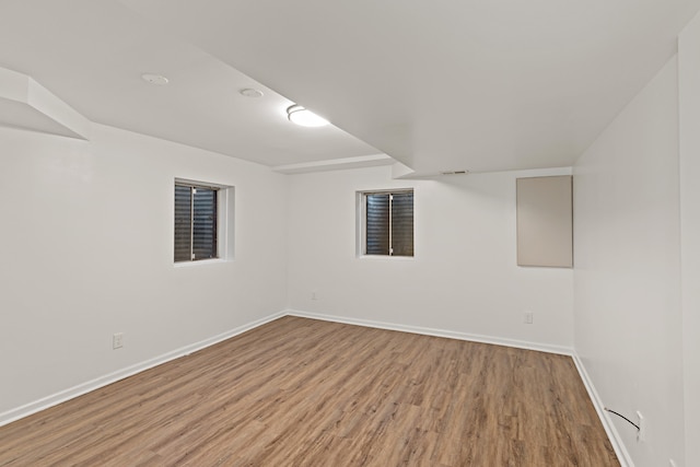 basement with hardwood / wood-style flooring