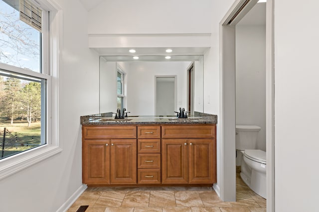 bathroom featuring vanity and toilet