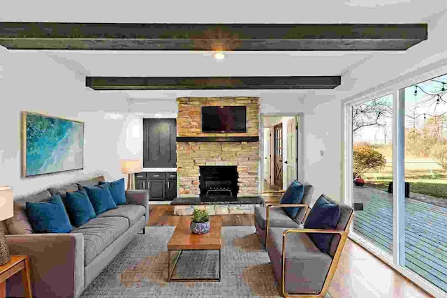 living room with a fireplace, beam ceiling, and hardwood / wood-style floors