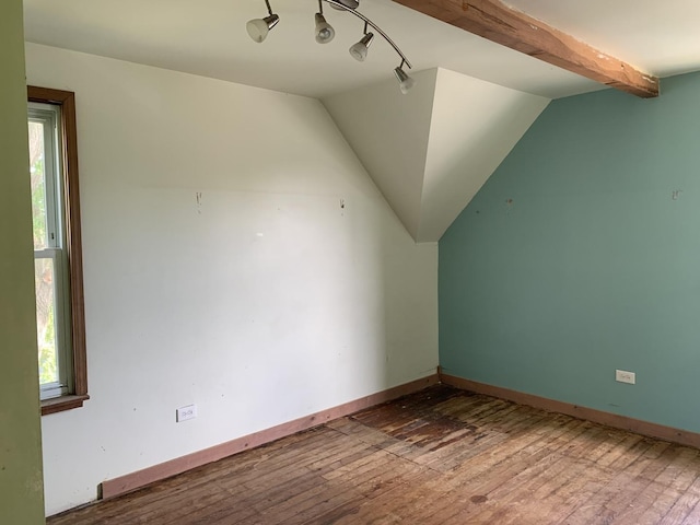 bonus room featuring lofted ceiling with beams and wood-type flooring