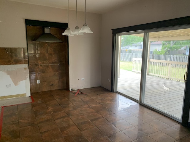 unfurnished dining area featuring tile patterned floors