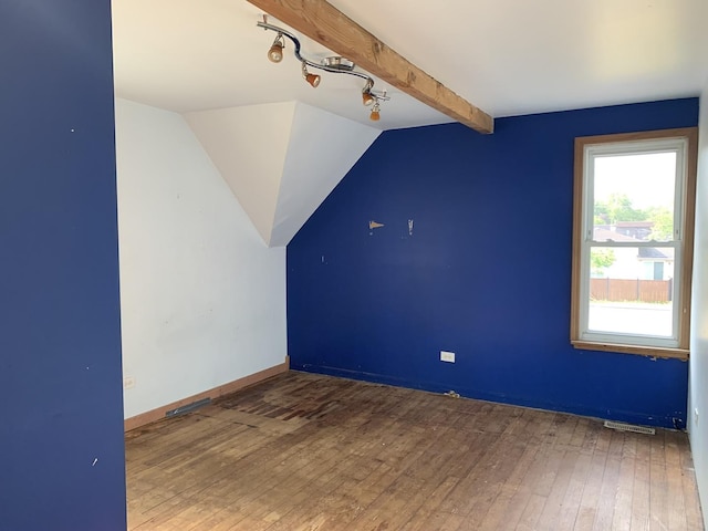 bonus room with lofted ceiling with beams and hardwood / wood-style flooring