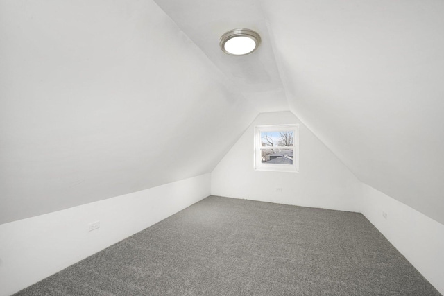 bonus room featuring carpet floors and vaulted ceiling