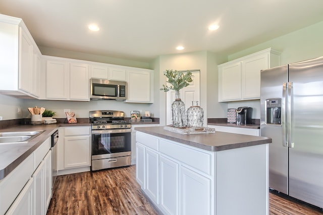 kitchen featuring a center island, dark hardwood / wood-style flooring, stainless steel appliances, and white cabinetry