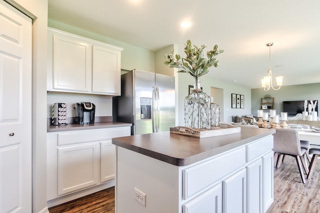 kitchen featuring a center island, stainless steel fridge with ice dispenser, dark hardwood / wood-style floors, a notable chandelier, and white cabinetry