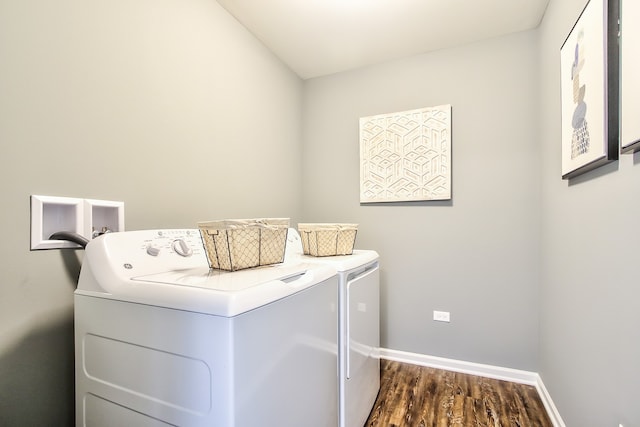 washroom featuring washing machine and dryer and dark wood-type flooring