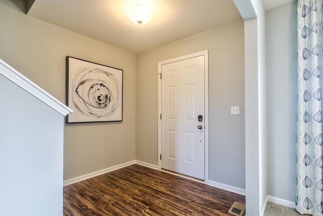 foyer with dark hardwood / wood-style floors