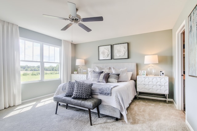 bedroom with ceiling fan and light colored carpet