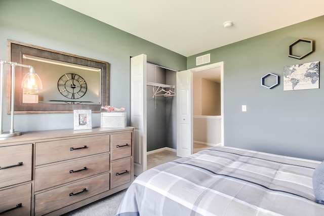 bedroom with a closet and light colored carpet