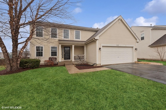 view of front facade with a garage, a front yard, and covered porch