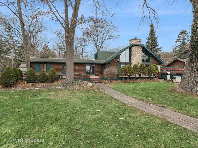 view of front facade featuring a chimney and a front yard