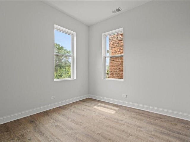 spare room with light hardwood / wood-style flooring