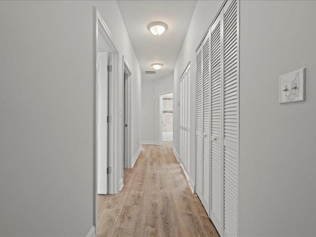 hall with light hardwood / wood-style flooring